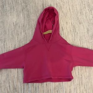 This is a pink lululemon cropped sweatshirt